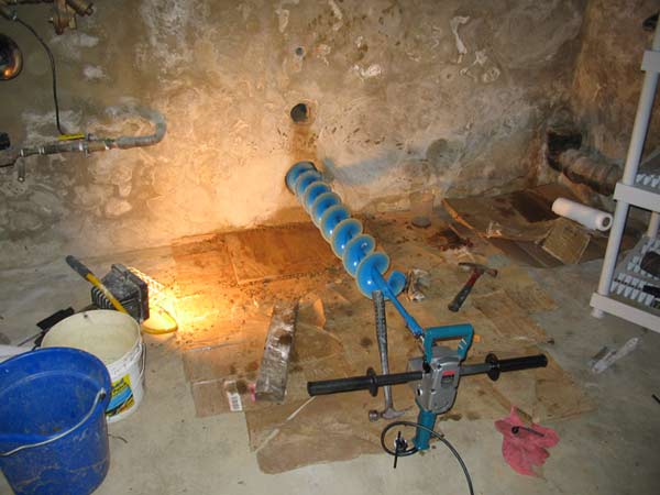 photo of horizontal auger boring project installing drain line out basement of home
